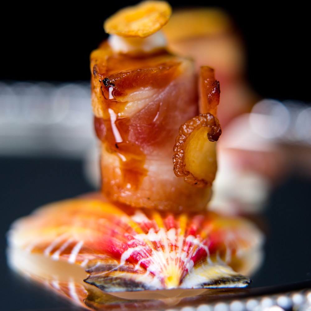 Seared spiced scallops wrapped in applewood bacon